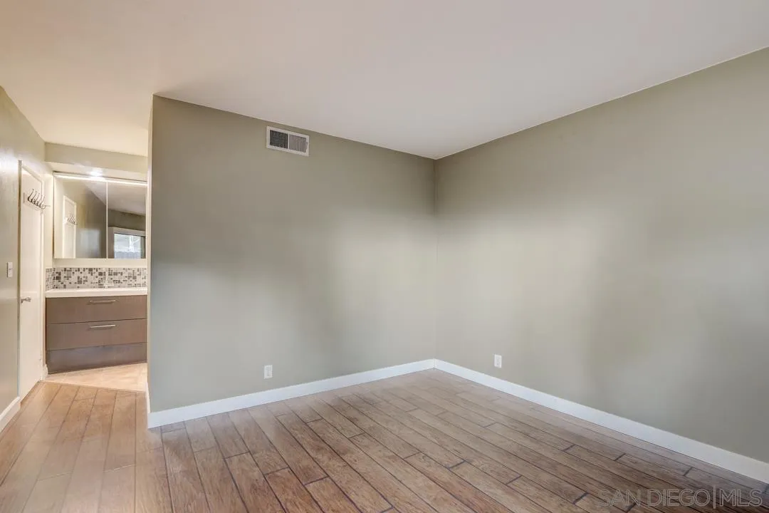 6395 Rancho Mission Road, Unit 15 San Diego, CA 92108 - Photo 16 of 21 wooden floor in an empty room