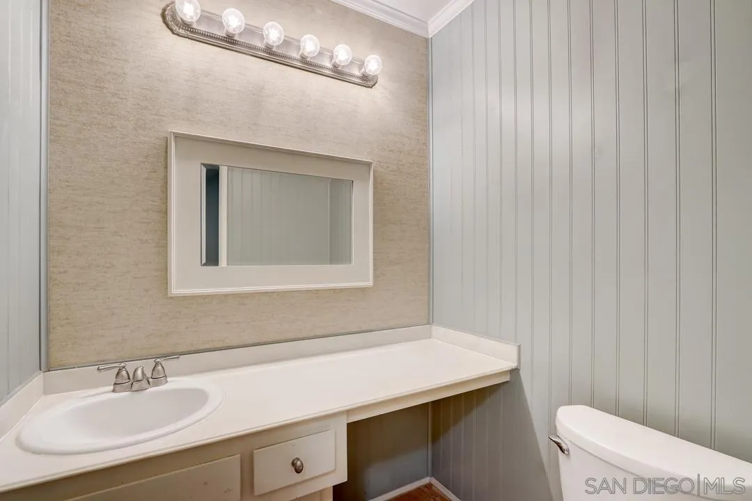 6395 Rancho Mission Road, Unit 15 San Diego, CA 92108 - Photo 17 of 21 a bathroom with a sink a toilet and a mirror