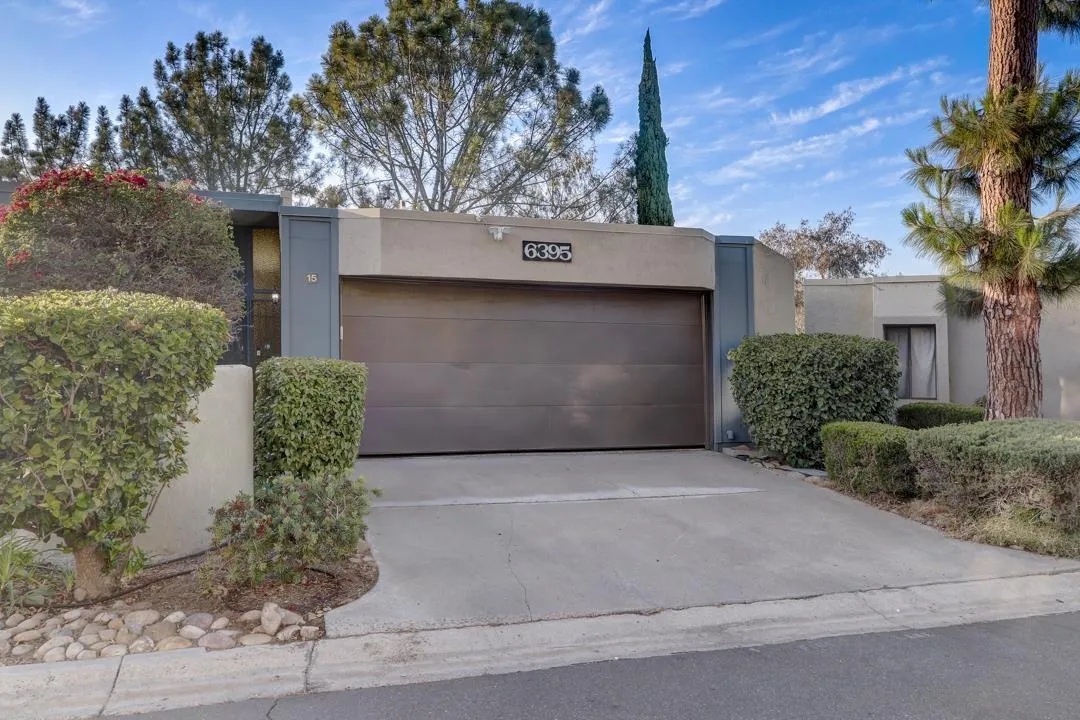 6395 Rancho Mission Road, Unit 15 San Diego, CA 92108 - Photo 21 of 21 a front view of a house with a yard and garage