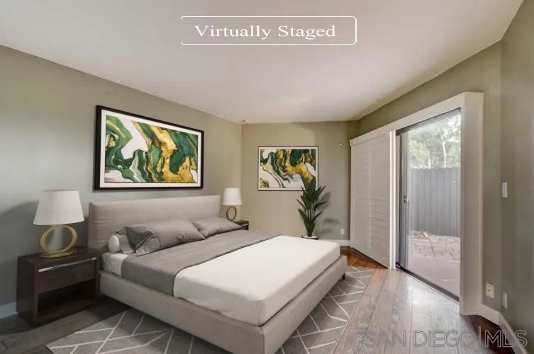 6395 Rancho Mission Road, Unit 15 San Diego, CA 92108 - Photo 3 of 21 a bedroom with a bed and a painting on the wall