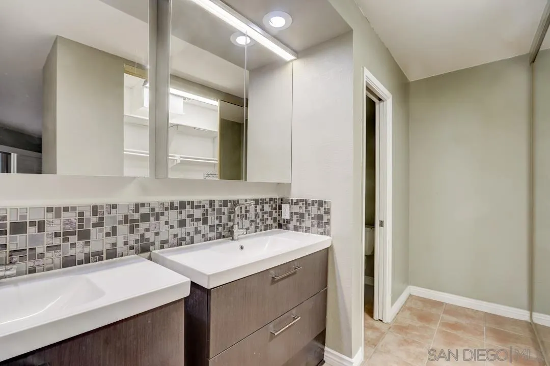 6395 Rancho Mission Road, Unit 15 San Diego, CA 92108 - Photo 6 of 21 a bathroom with a sink and a mirror