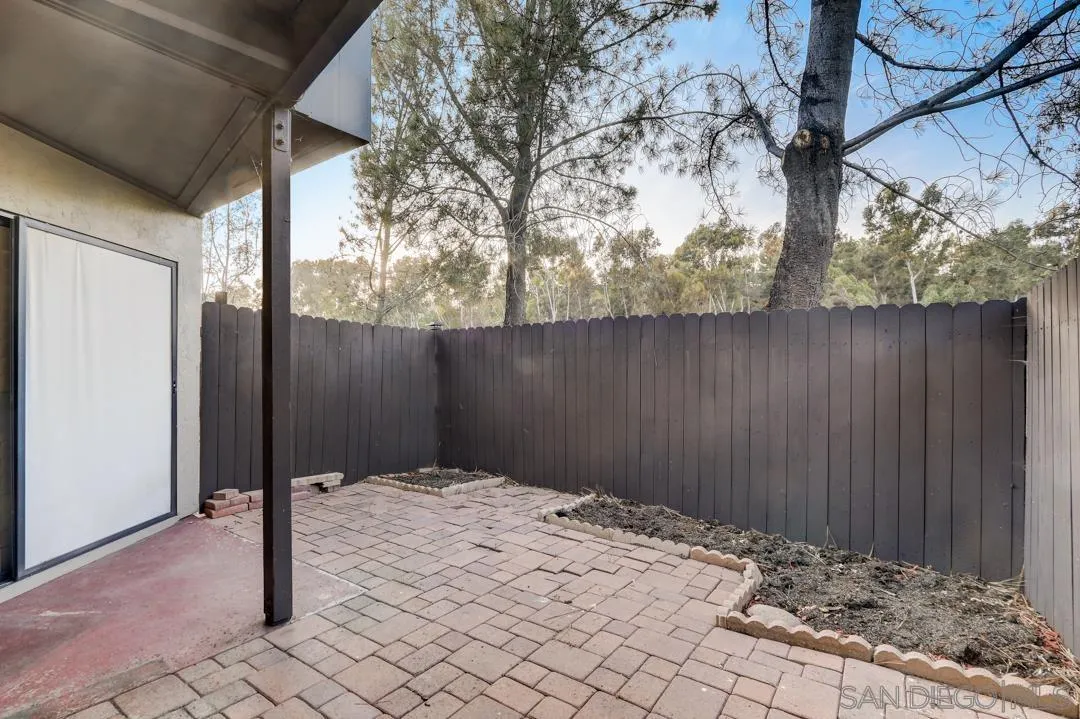 6395 Rancho Mission Road, Unit 15 San Diego, CA 92108 - Photo 7 of 21 a backyard of a house with wooden fence