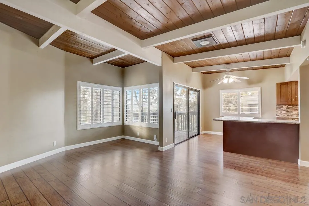 6395 Rancho Mission Road, Unit 15 San Diego, CA 92108 - Photo 8 of 21 a view of an empty room with wooden floor and a window