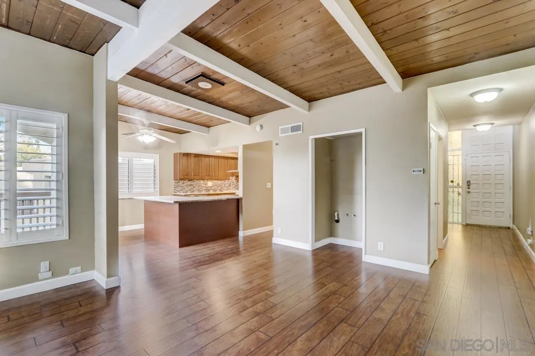 6395 Rancho Mission Road, Unit 15 San Diego, CA 92108 - Photo 9 of 21 a view of an empty room with wooden floor and a window