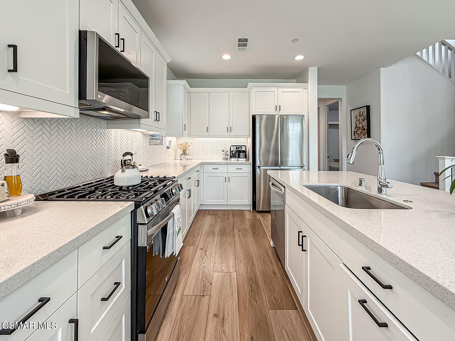 335 Fraser Point Camarillo, CA 93012 - Photo 13 of 85 a kitchen with stainless steel appliances a stove sink microwave and cabinets