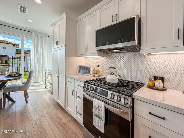 a view of a house with pool and chairs