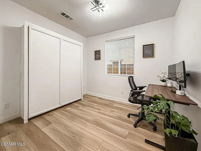 a spacious bedroom with a bed and a large window