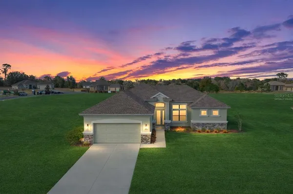 a view of a big house with a big yard