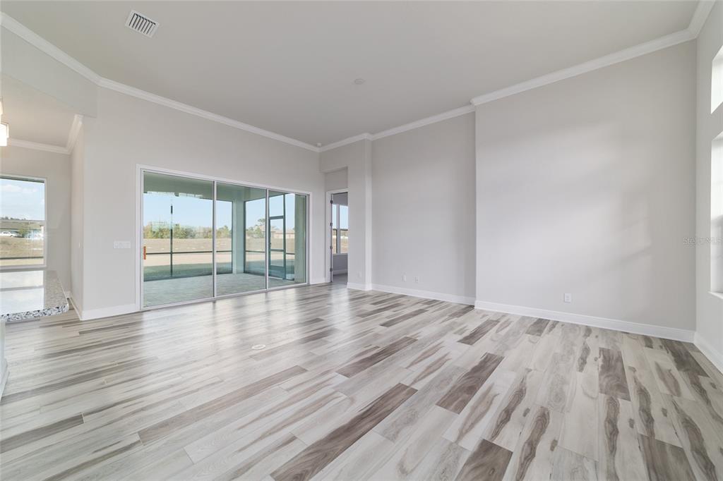 1499 East Pegasus Lane Inverness, FL 34453 - Photo 18 of 46 wooden floor in an empty room with a window