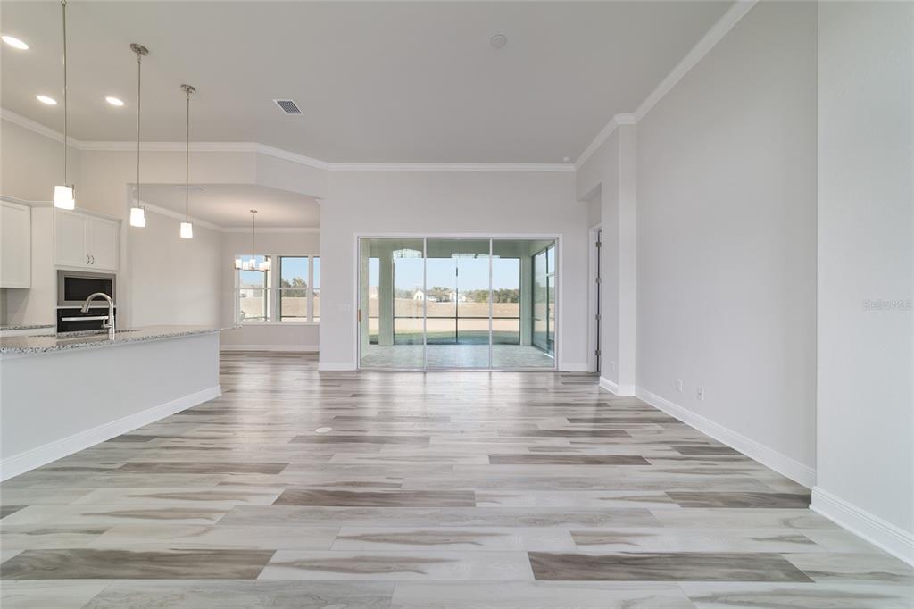 1499 East Pegasus Lane Inverness, FL 34453 - Photo 19 of 46 a view of an empty room with wooden floor and a window