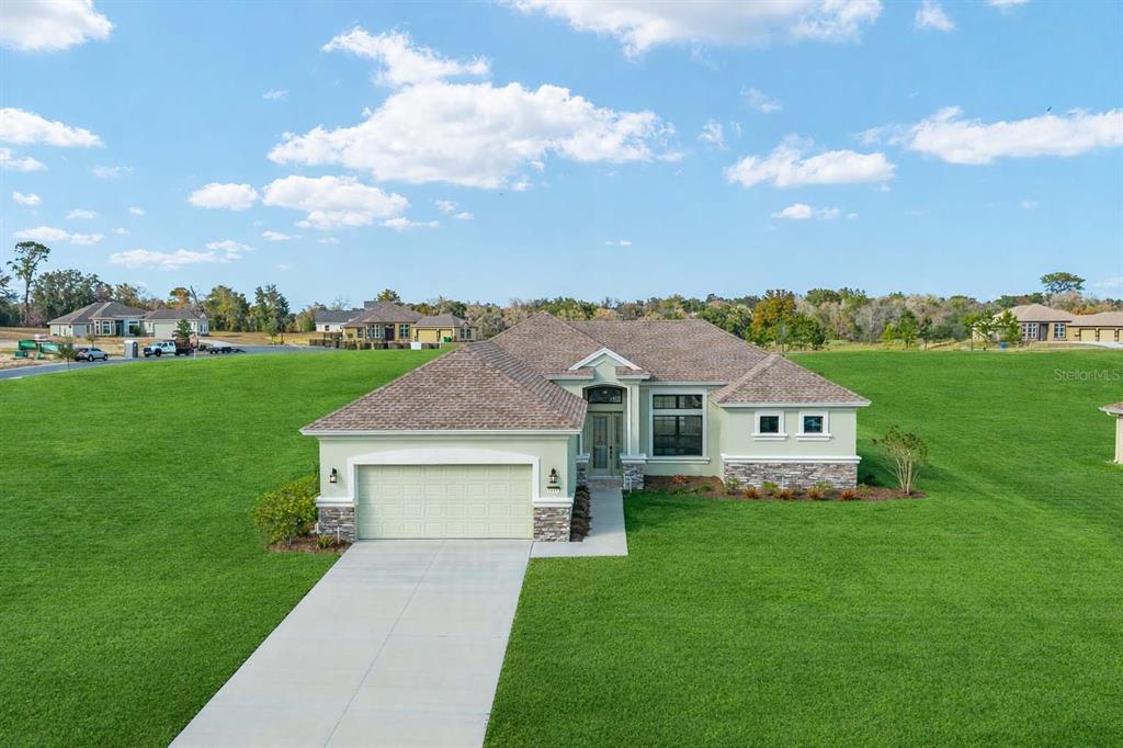 1499 East Pegasus Lane Inverness, FL 34453 - Photo 2 of 46 a aerial view of a house with a big yard and large trees