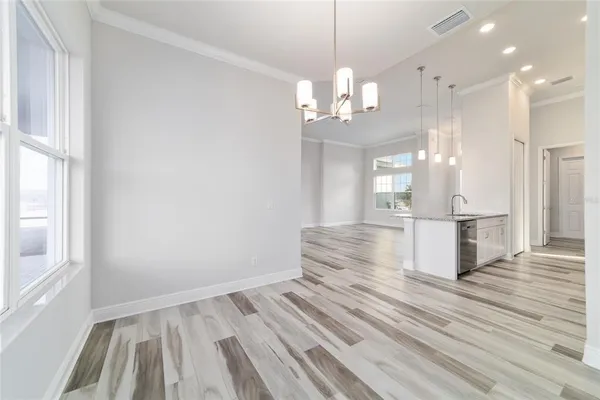 a view of a room with wooden floor and windows