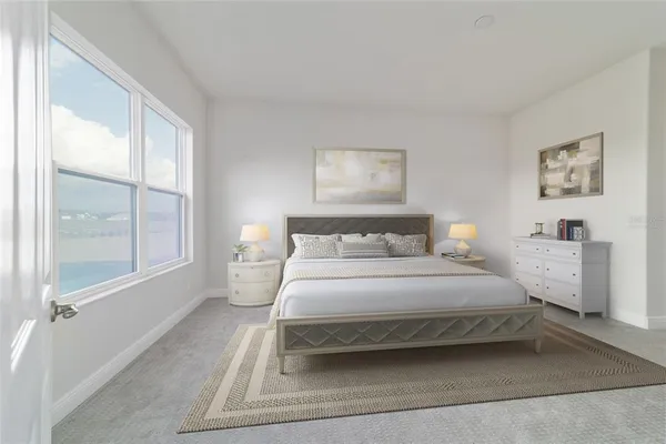 a bedroom with a bed and a large window