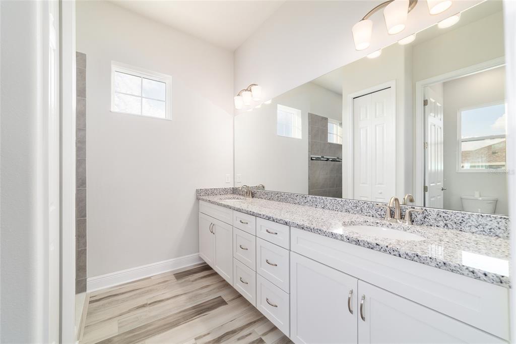 1499 East Pegasus Lane Inverness, FL 34453 - Photo 30 of 46 a bathroom with a granite countertop sink and a mirror