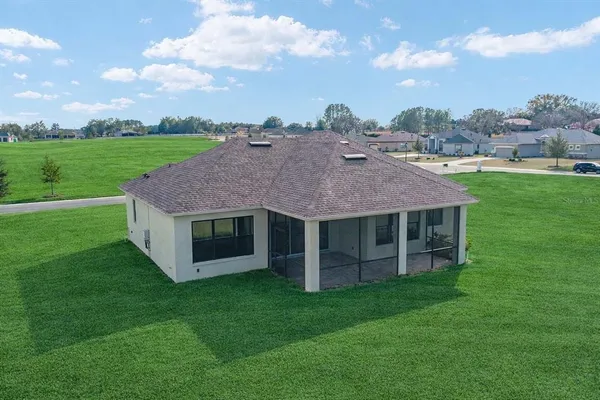 a aerial view of a house with a garden and a yard