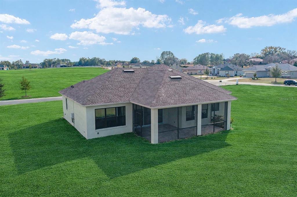 1499 East Pegasus Lane Inverness, FL 34453 - Photo 4 of 46 a aerial view of a house with a garden and a yard
