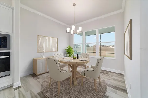 a dining room with furniture a chandelier and window