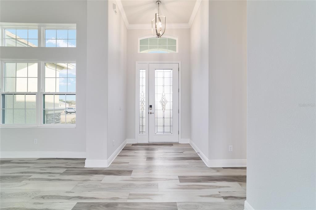 1499 East Pegasus Lane Inverness, FL 34453 - Photo 8 of 46 a view of a room with wooden floor and windows