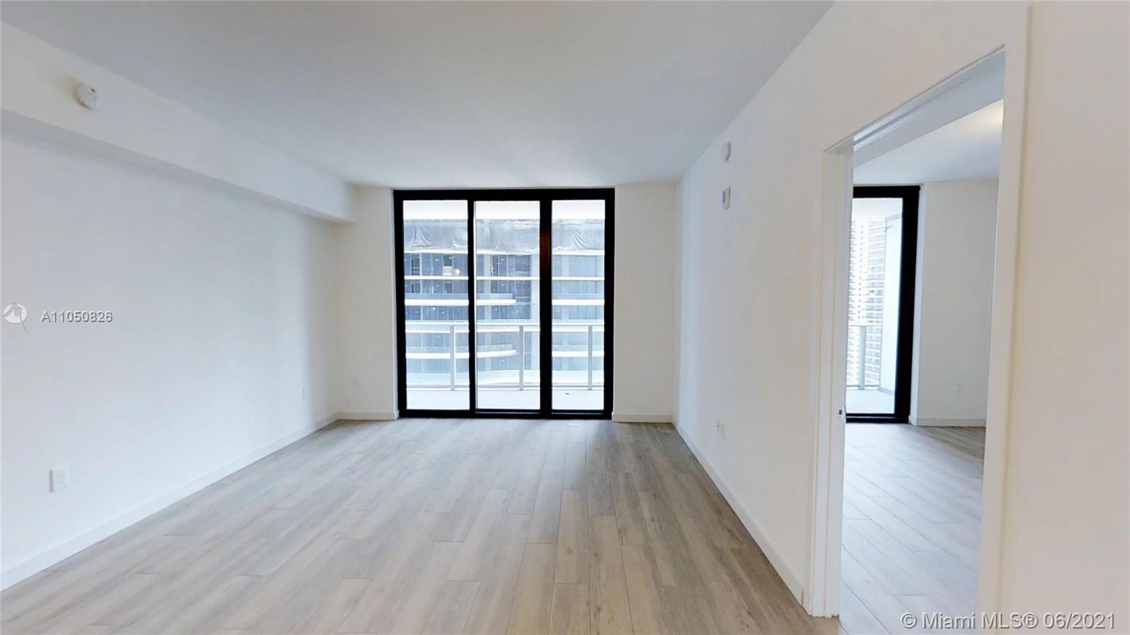 1010 Brickell Avenue, Unit 3209 Miami, FL 33131 - Photo 2 of 31 wooden floor in an empty room with a window