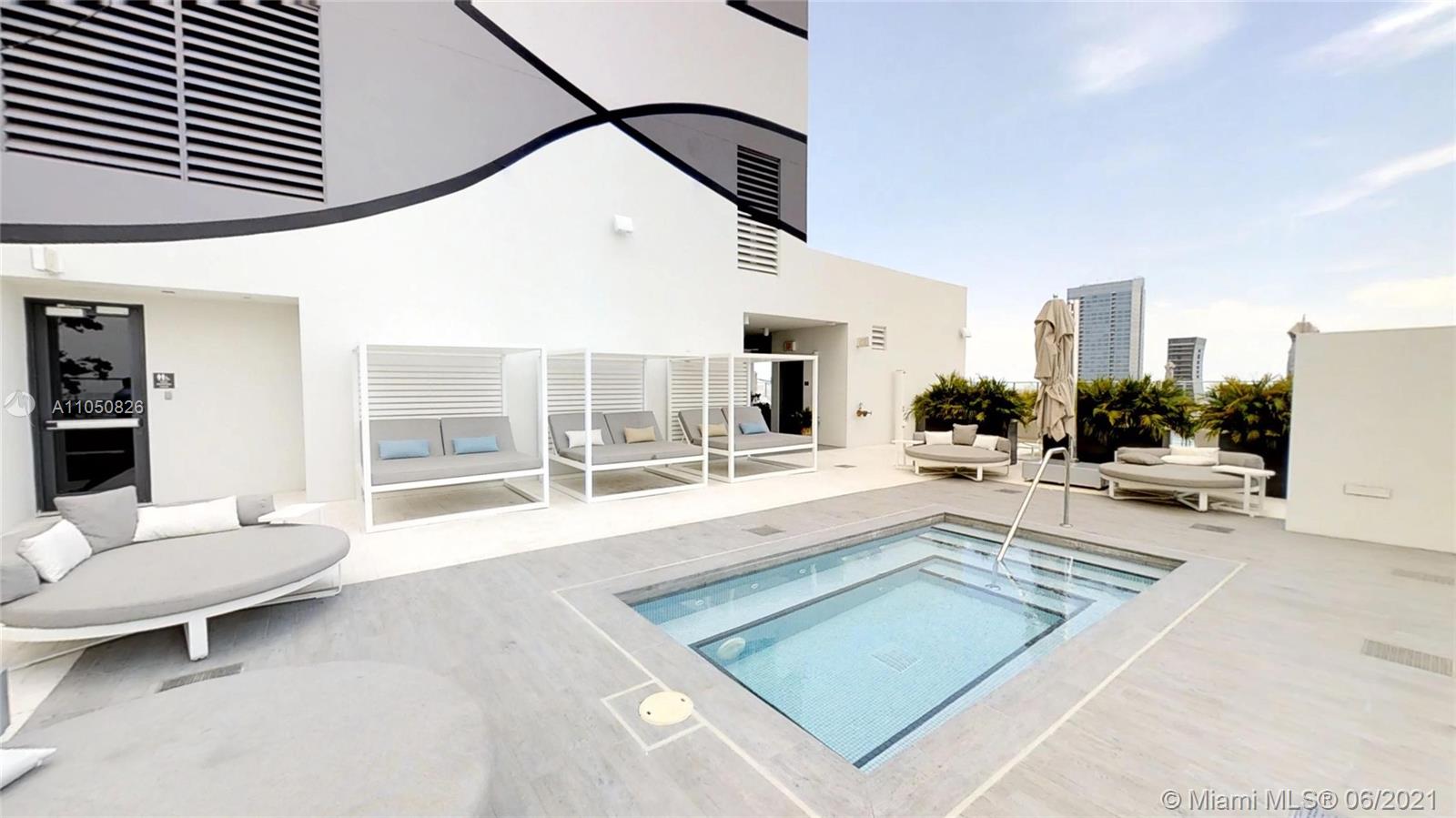 1010 Brickell Avenue, Unit 3209 Miami, FL 33131 - Photo 21 of 31 a living room with furniture a rug and white walls