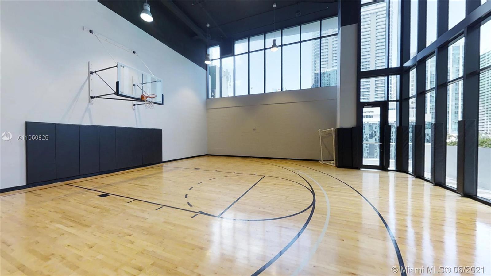 1010 Brickell Avenue, Unit 3209 Miami, FL 33131 - Photo 24 of 31 a bedroom with a bed and wooden floor