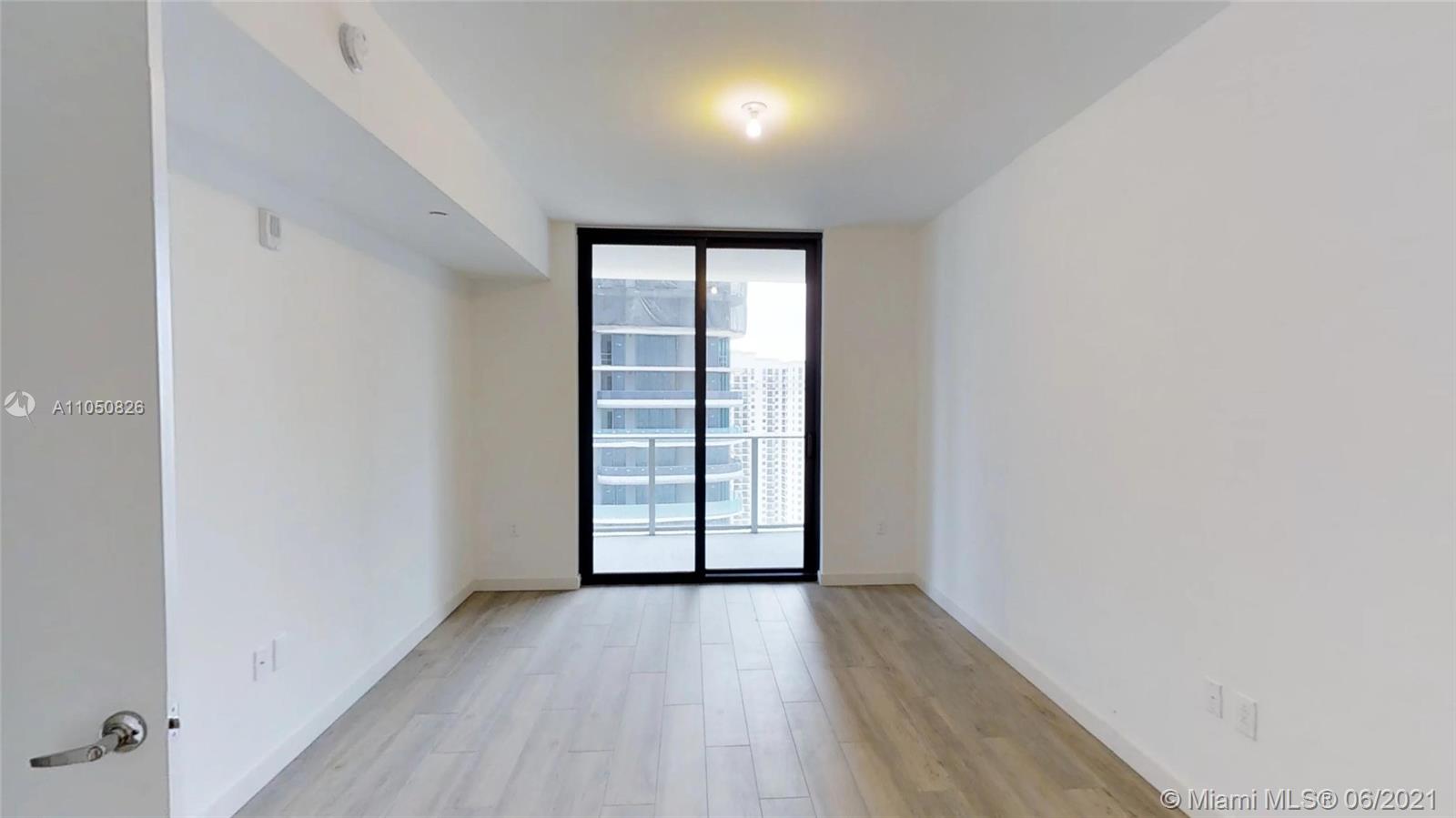 1010 Brickell Avenue, Unit 3209 Miami, FL 33131 - Photo 7 of 31 wooden floor in an empty room with a window