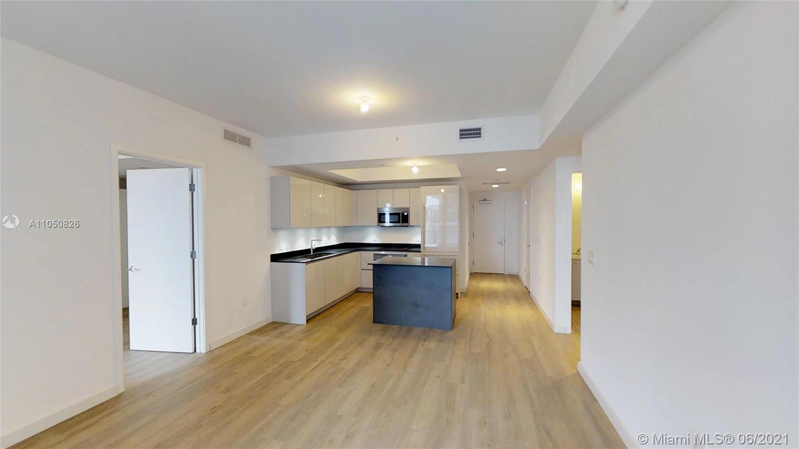 1010 Brickell Avenue, Unit 3209 Miami, FL 33131 - Photo 8 of 31 a kitchen with a refrigerator and a sink