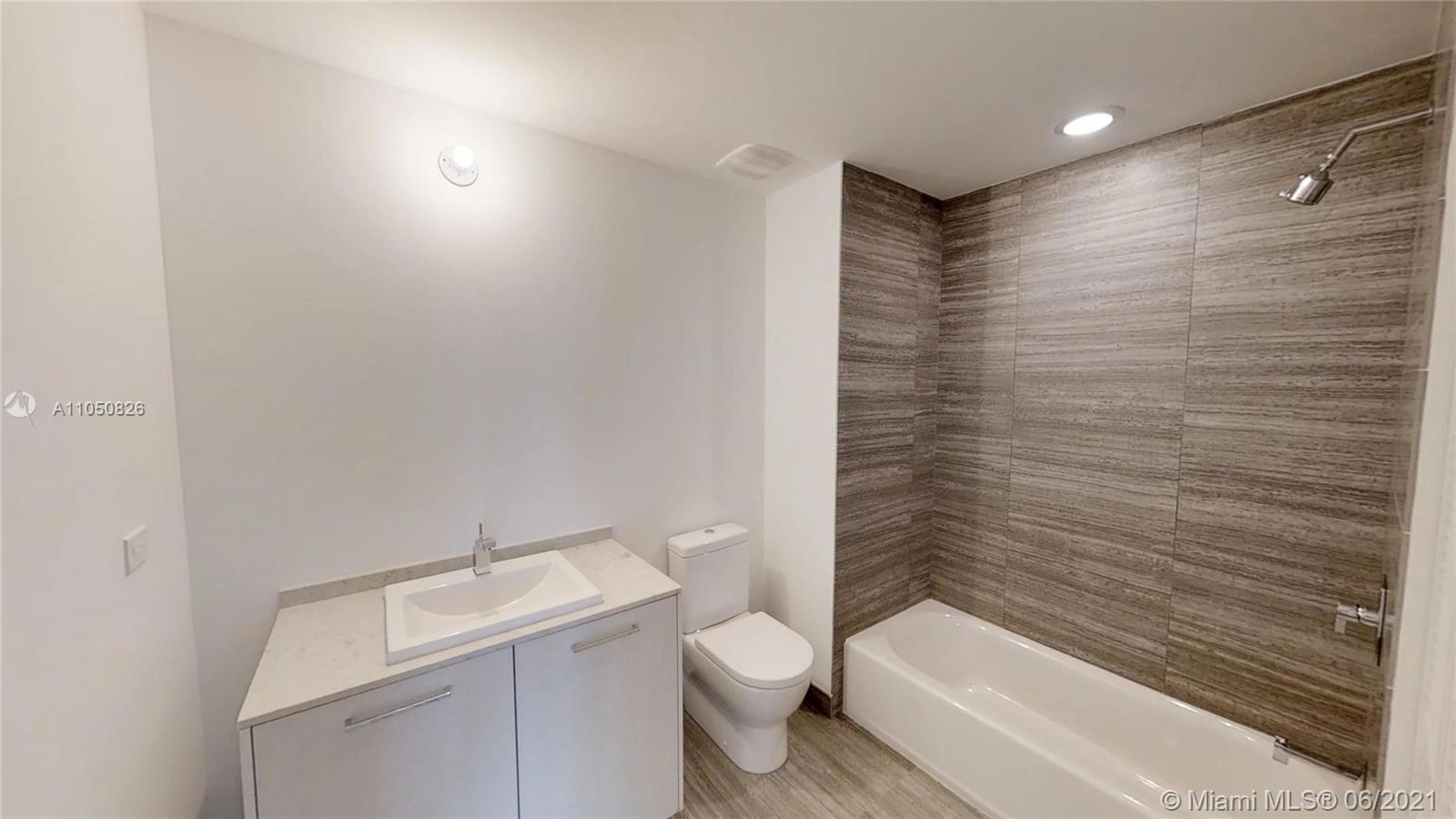 1010 Brickell Avenue, Unit 3209 Miami, FL 33131 - Photo 9 of 31 a bathroom with a toilet a sink and bathtub