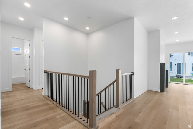 43 South Crimson Way, Unit 311 Mapleton, UT 84664 - Photo 9 of 28 Open-concept upper landing featuring wood-finish flooring, recessed lighting, and a contemporary wood and metal railing system