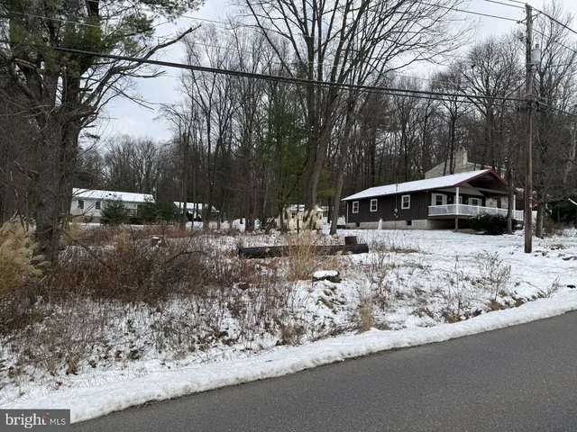 a view of house with a yard and sitting area