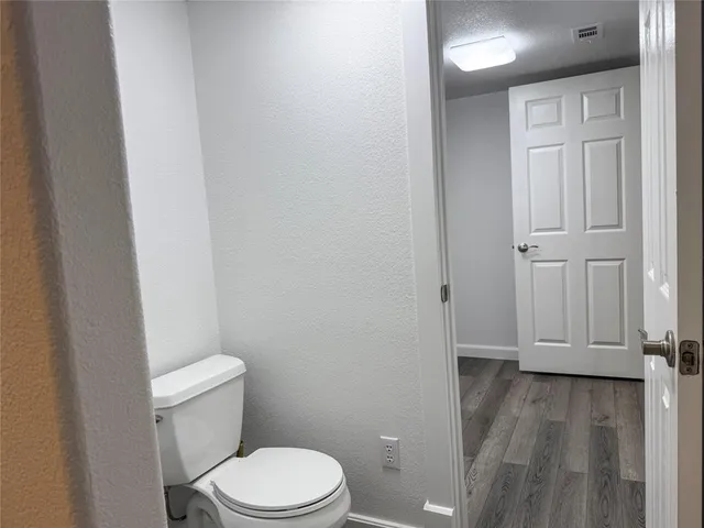 a white toilet sitting next to a bathroom sink