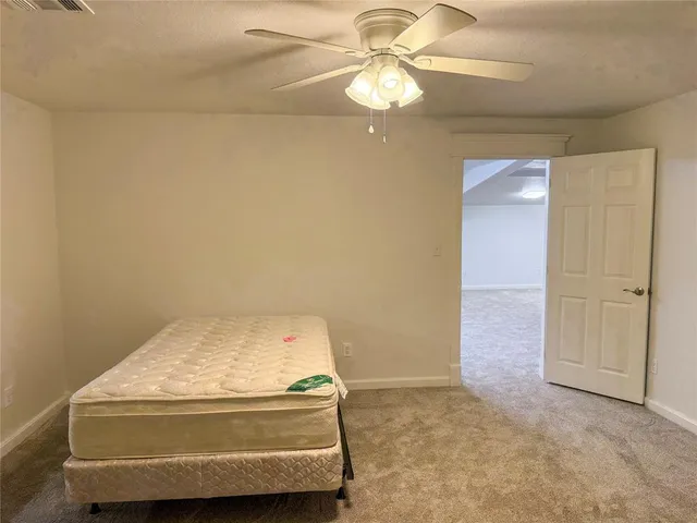 an empty room with a ceiling fan
