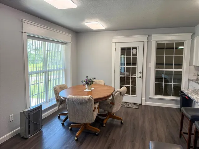 a view of a dining room with furniture and a window