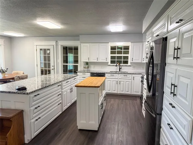 a kitchen with a sink stove and refrigerator