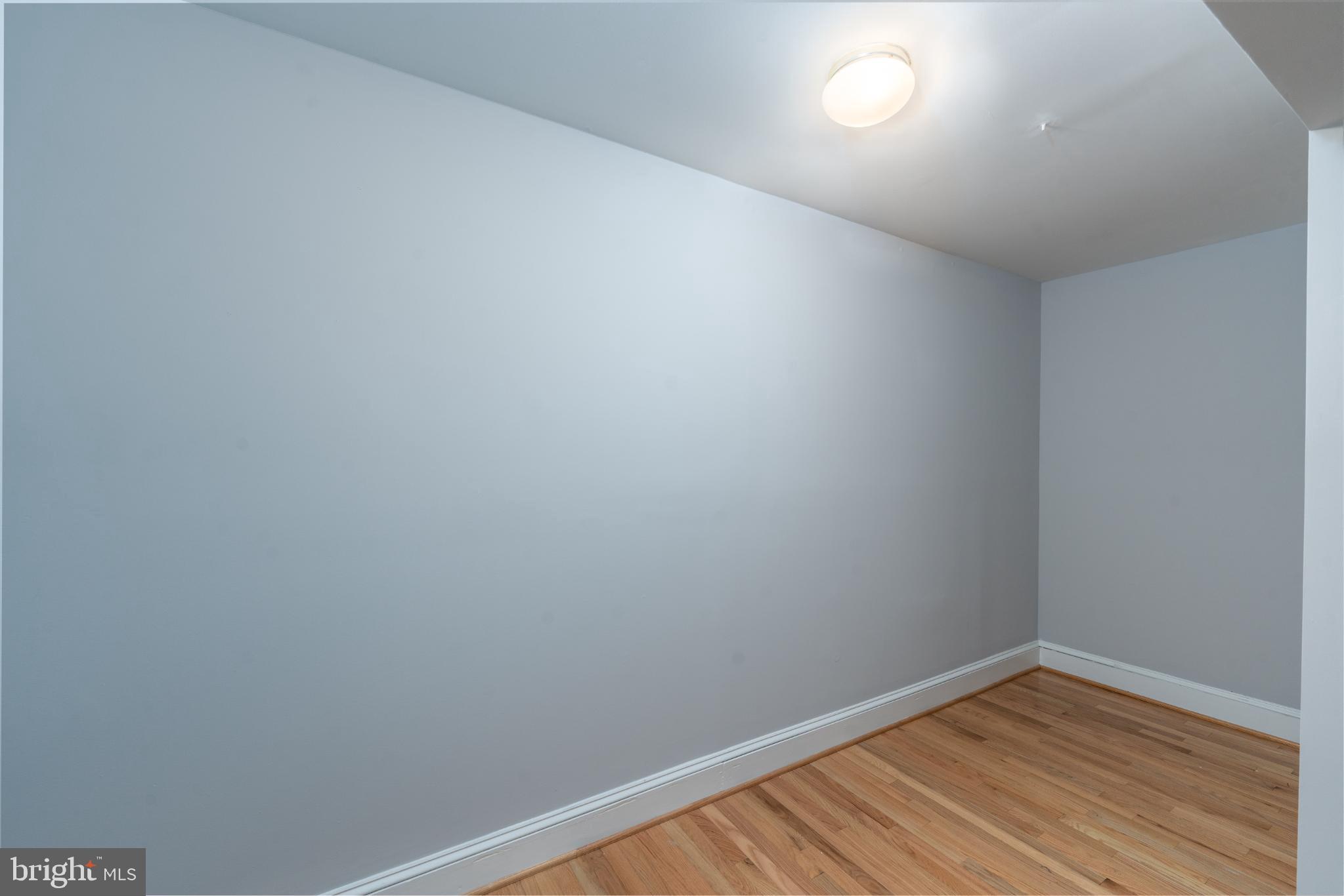 14 East Mt Vernon Place, Unit 15 Baltimore, MD 21202 - Photo 11 of 29 a view of room with wooden floor and fan
