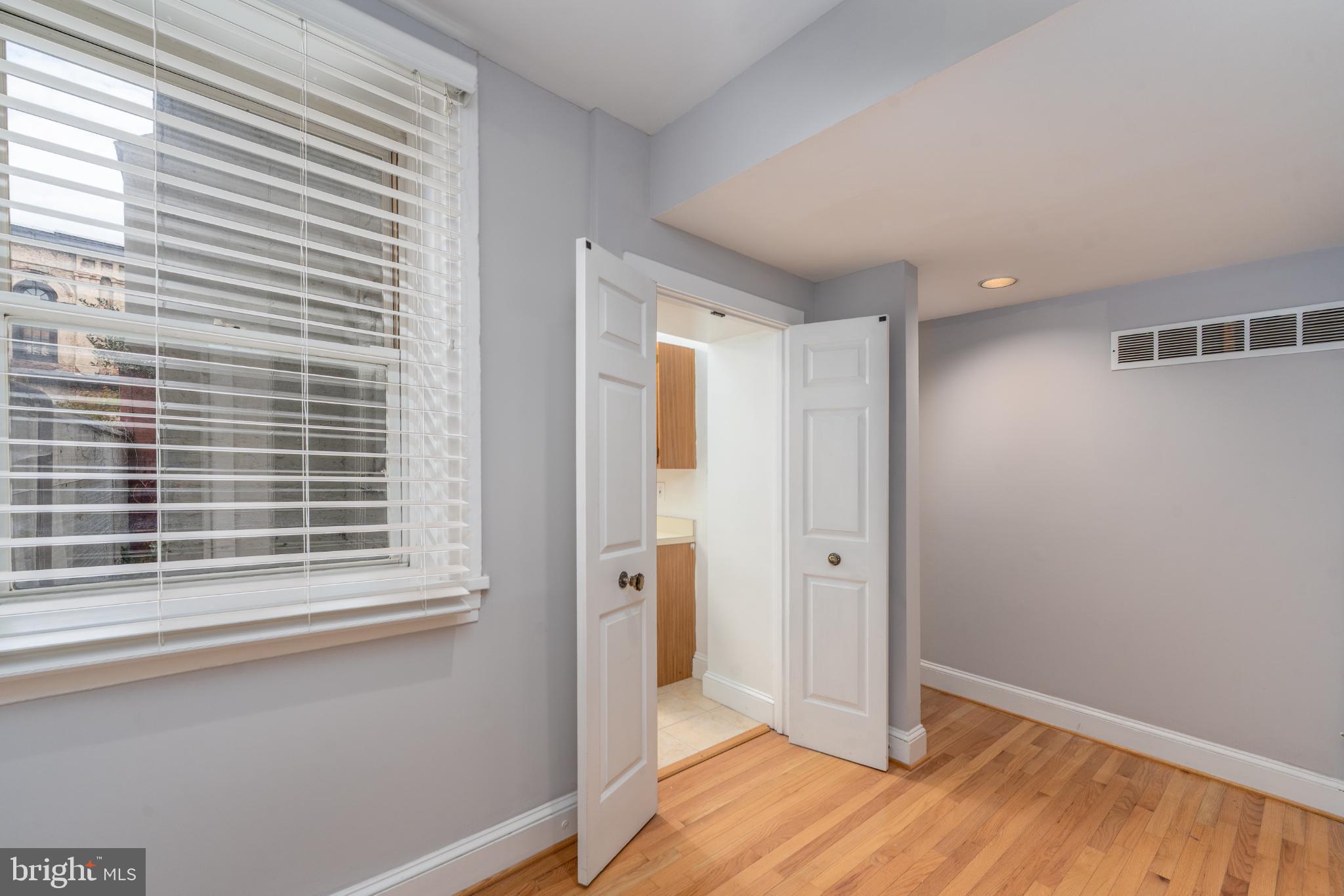 14 East Mt Vernon Place, Unit 15 Baltimore, MD 21202 - Photo 13 of 29 a view of an empty room with wooden floor and a window