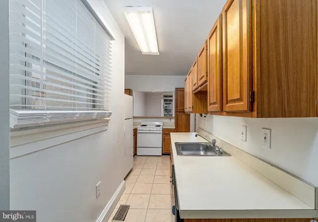 a kitchen with stainless steel appliances granite countertop a refrigerator a stove and a sink