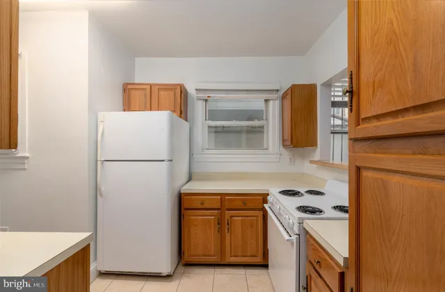 a kitchen with a refrigerator a stove top oven a sink and dishwasher