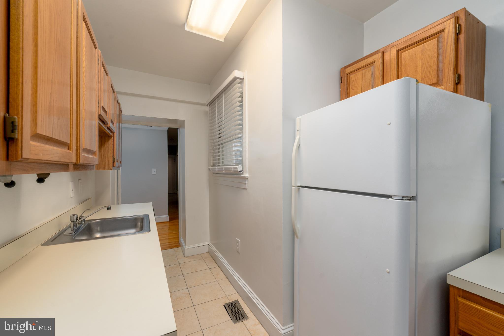 14 East Mt Vernon Place, Unit 15 Baltimore, MD 21202 - Photo 17 of 29 a white refrigerator freezer sitting in a kitchen