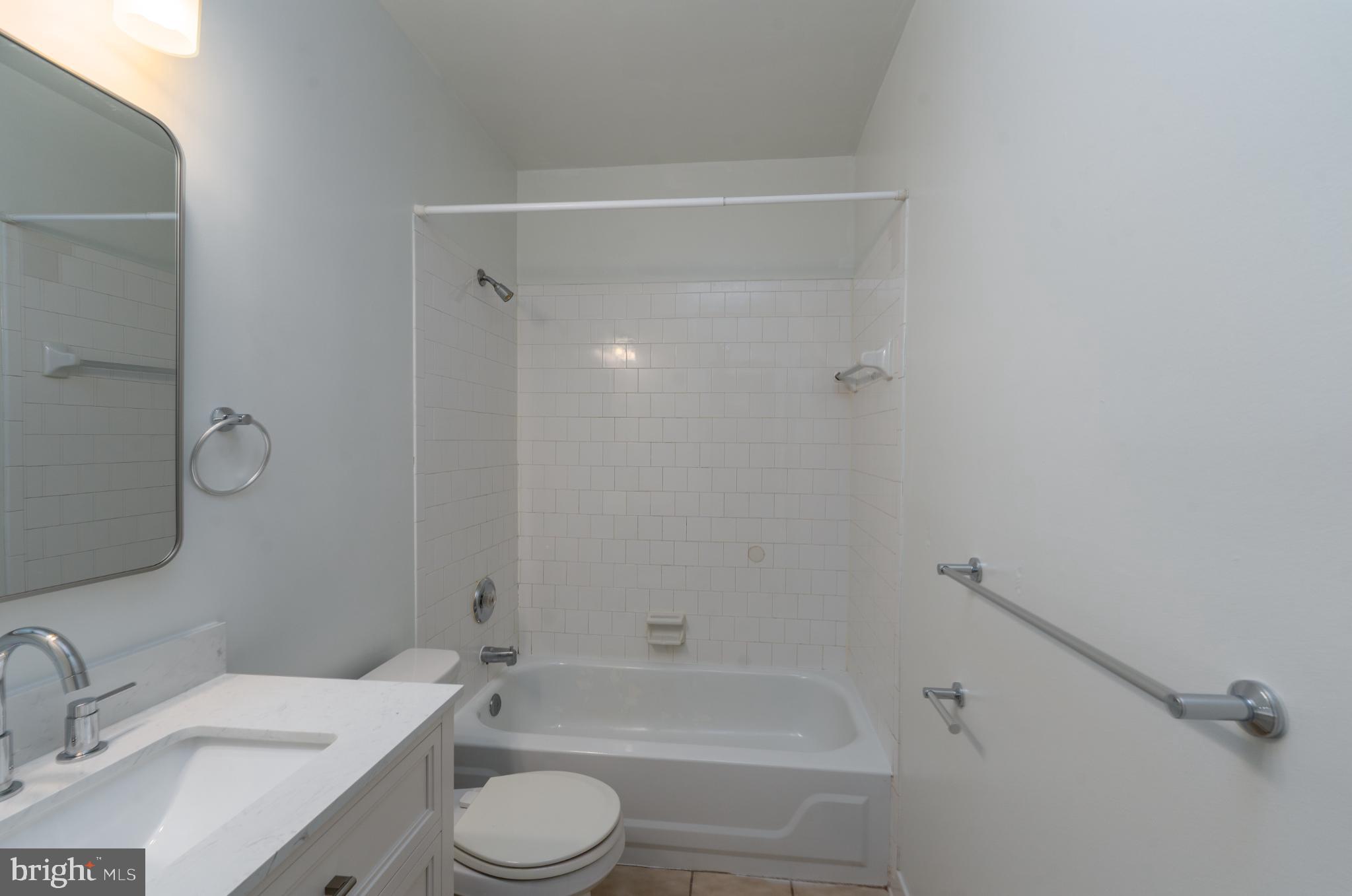 14 East Mt Vernon Place, Unit 15 Baltimore, MD 21202 - Photo 20 of 29 a bathroom with a sink toilet and shower