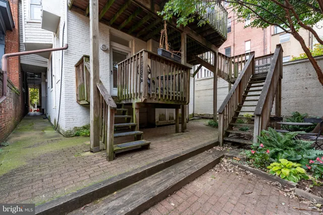 a view of a house with a small deck