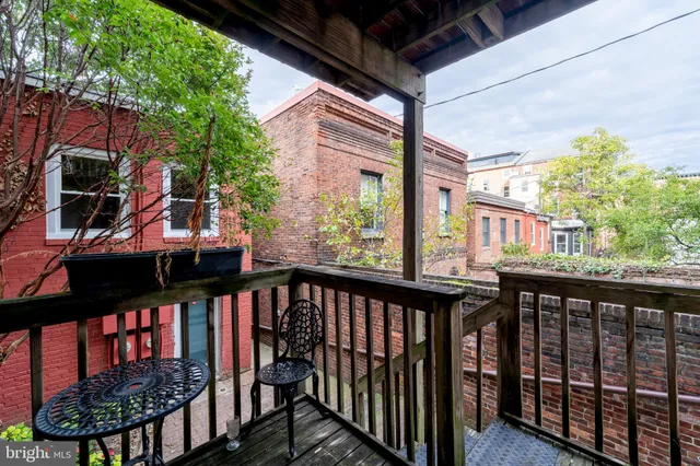 a view of a balcony with wooden floor and outdoor space