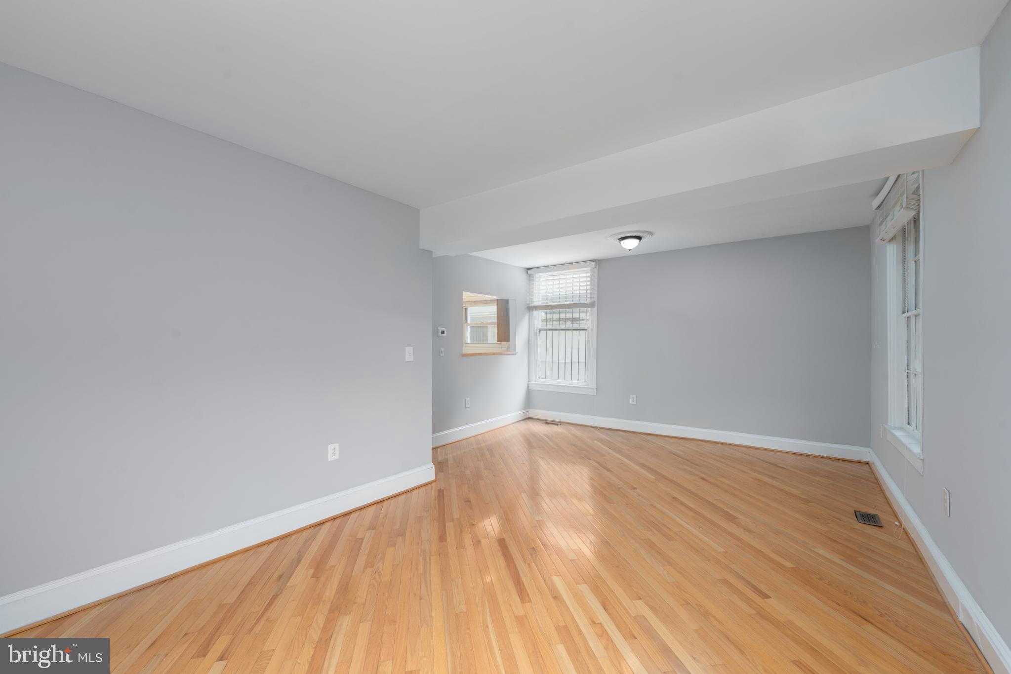 14 East Mt Vernon Place, Unit 15 Baltimore, MD 21202 - Photo 5 of 29 a view of an empty room with wooden floor and a window