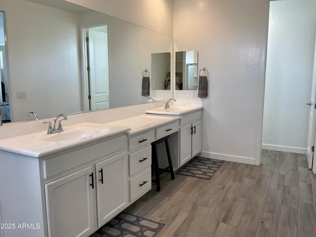 a bathroom with a double vanity sink and mirror