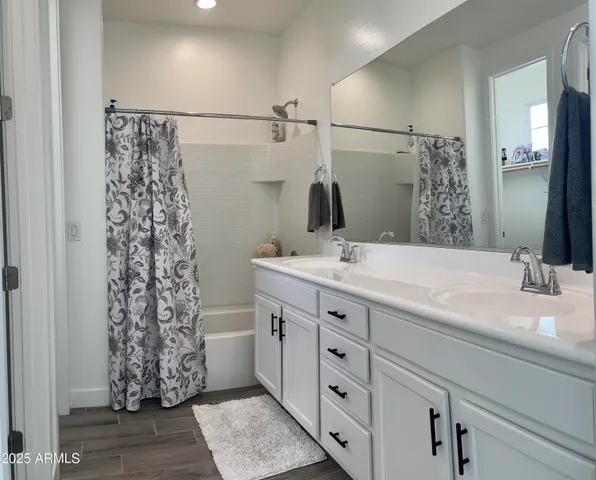 a bathroom with a double vanity sink and a mirror