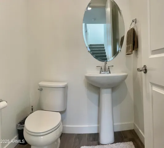 a bathroom with a sink toilet and mirror
