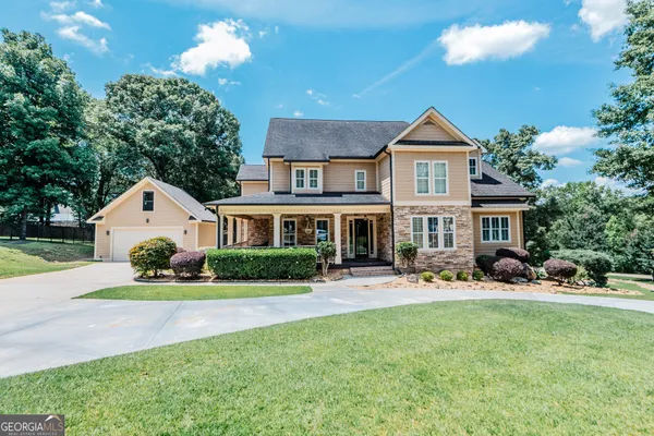 a front view of a house with a yard