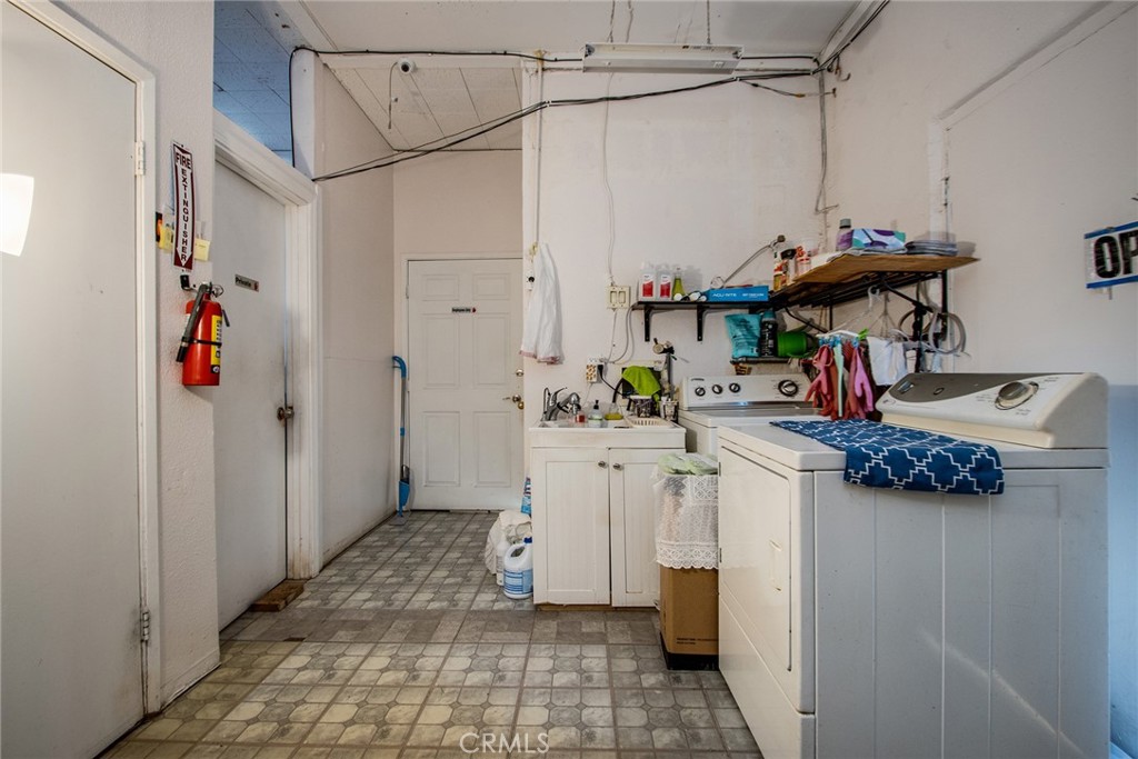 5929 Adobe Road Twentynine Palms, CA 92277 - Photo 11 of 33 a kitchen with a sink and refrigerator