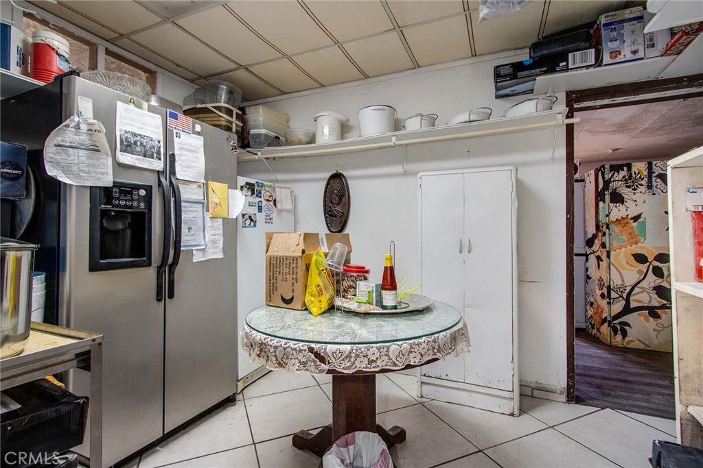 5929 Adobe Road Twentynine Palms, CA 92277 - Photo 22 of 33 a room with stainless steel appliances kitchen island granite countertop furniture and a refrigerator