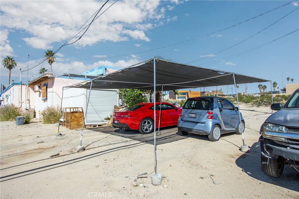 5929 Adobe Road Twentynine Palms, CA 92277 - Photo 29 of 33 a view of a cars park in front of house